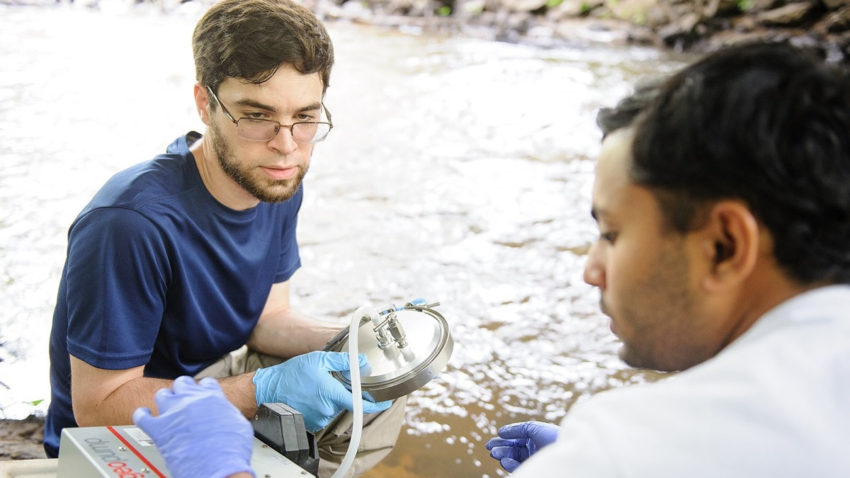 University of Alabama graduate student Aaron Blackwell, left, works with fellow graduate student Parnab Dason on an earlier project studying straight pipe drainage. (University of Alabama)